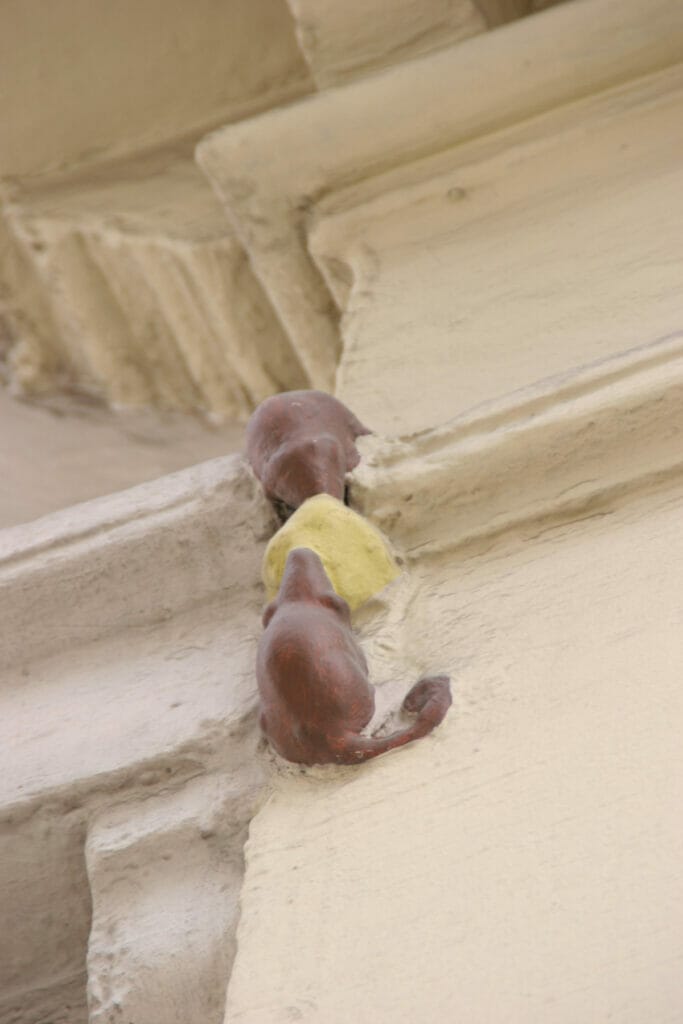 small statue of two mice eating cheese